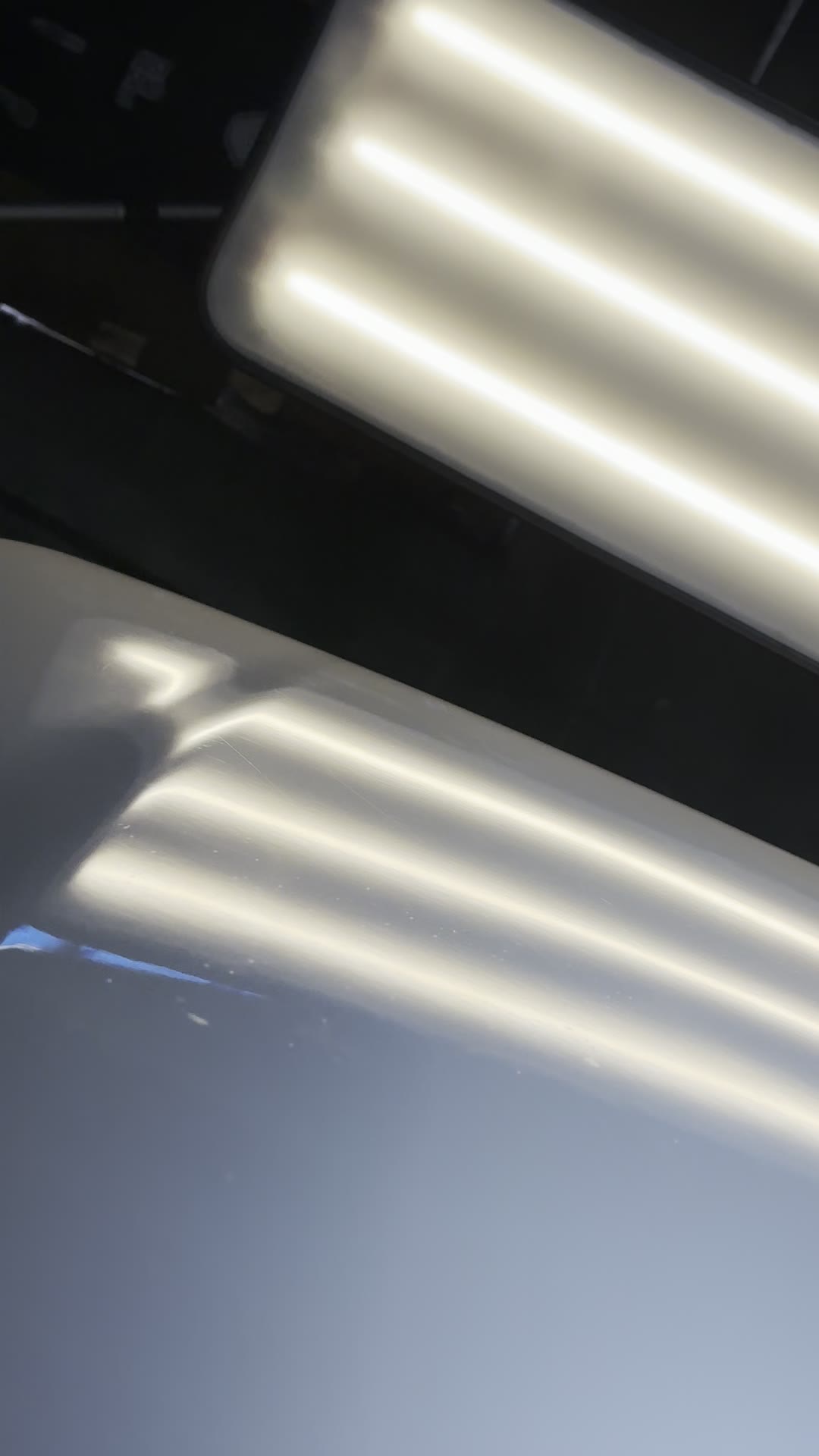The same hood after paintless dent repair, flawless under the lights